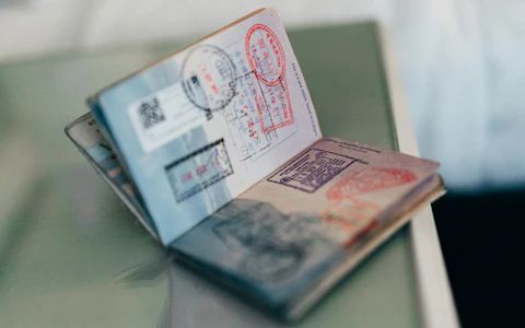 An open passport with entry stamps